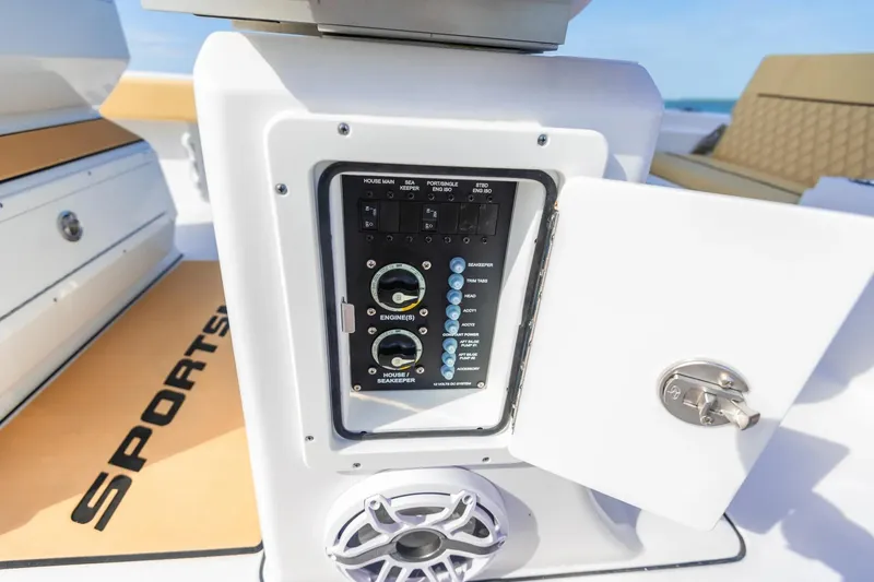 Slide: The Image of Control panel on 2026 Sportsman Masters 267 Bay Boat, open compartment, ocean background. - 17