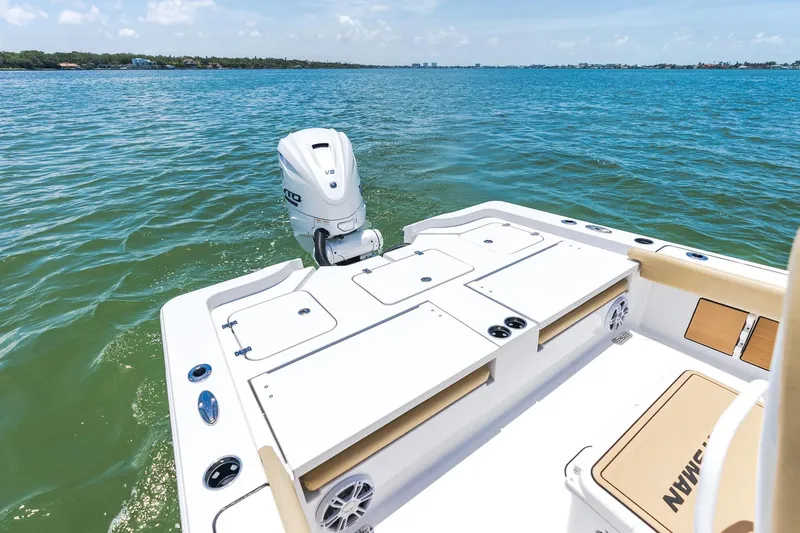 Slide: The Image of 2026 Sportsman Masters 267 Bay Boat on calm blue waters, showcasing rear deck and engine. - 20