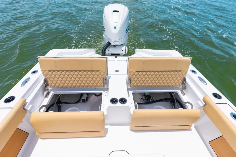 Slide: The Image of 2026 Sportsman Masters 267 Bay Boat with tan seating and outboard motor on water. - 22