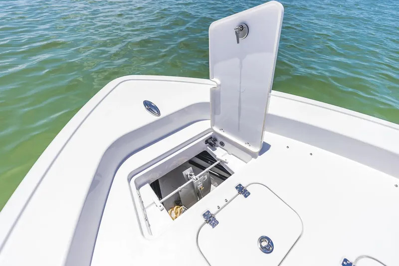 Slide: The Image of 2026 Sportsman Masters 267 Bay Boat anchor locker open on calm water. - 3