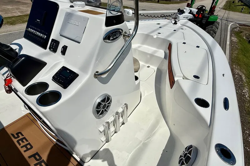 Slide: The Image of 2021 Sea Pro 208 Bay boat interior with console, cup holders, and seating area. - 14