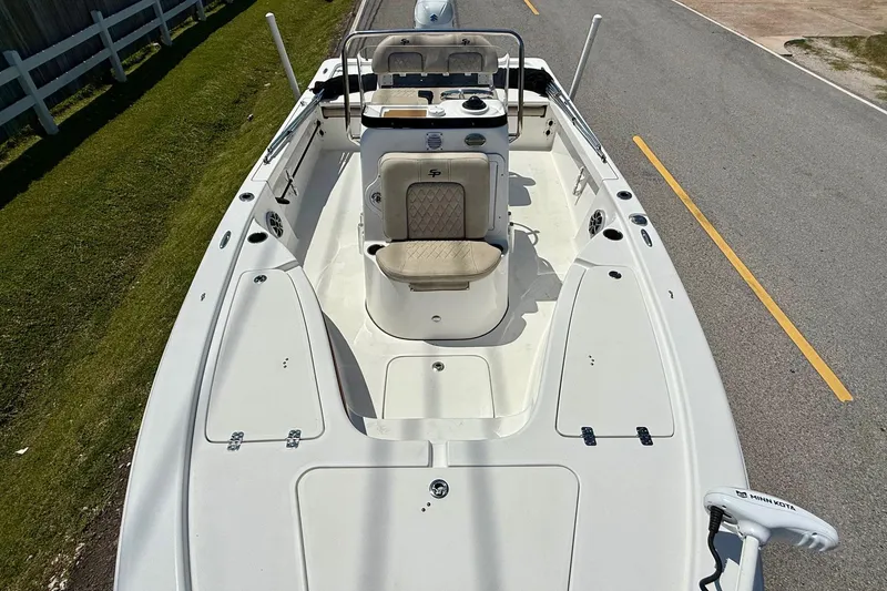 Slide: The Image of 2021 Sea Pro 208 Bay boat interior with seating and console, parked on roadside. - 15