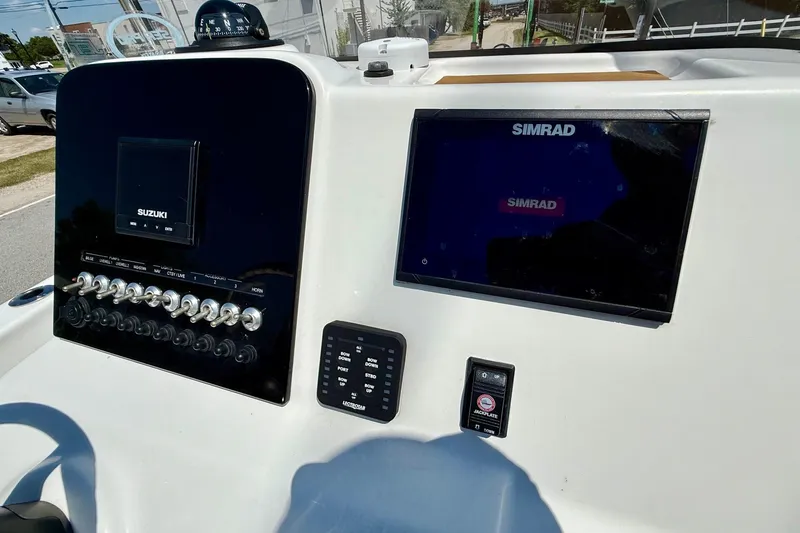 Slide: The Image of 2021 Sea Pro 208 Bay boat dashboard with Suzuki and Simrad displays. - 16