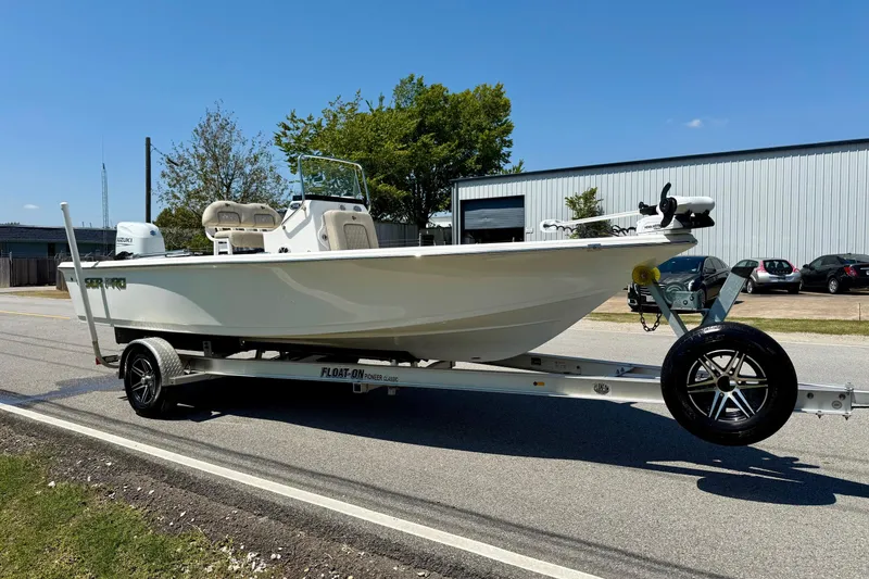 Slide: The Image of 2021 Sea Pro 208 Bay boat on trailer, parked on a sunny street. - 5
