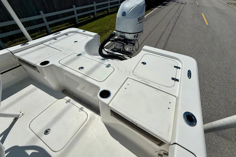 Slide: The Image of 2021 Sea Pro 208 Bay boat deck with Suzuki outboard motor, featuring storage compartments. - 8