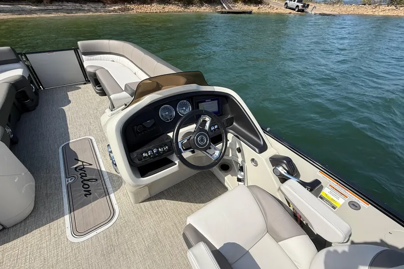 Slide: The Image of 2023 Avalon Catalina Versatile Rear Bench boat interior with steering console and seating. - 22