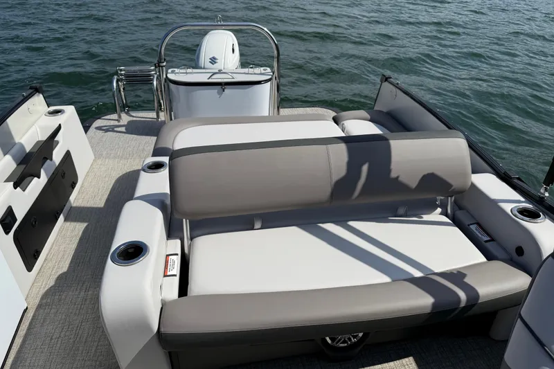 Slide: The Image of 2023 Avalon Catalina Versatile Rear Bench boat on water, featuring comfortable seating. - 23