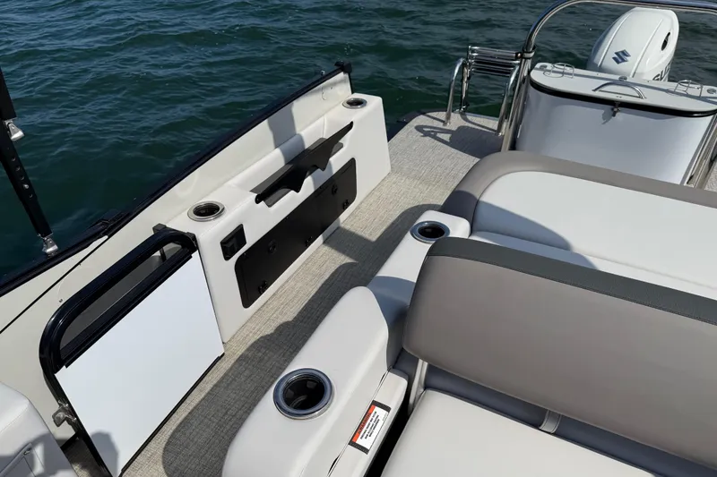 Slide: The Image of 2023 Avalon Catalina Versatile Rear Bench boat interior with seating and cup holders. - 24