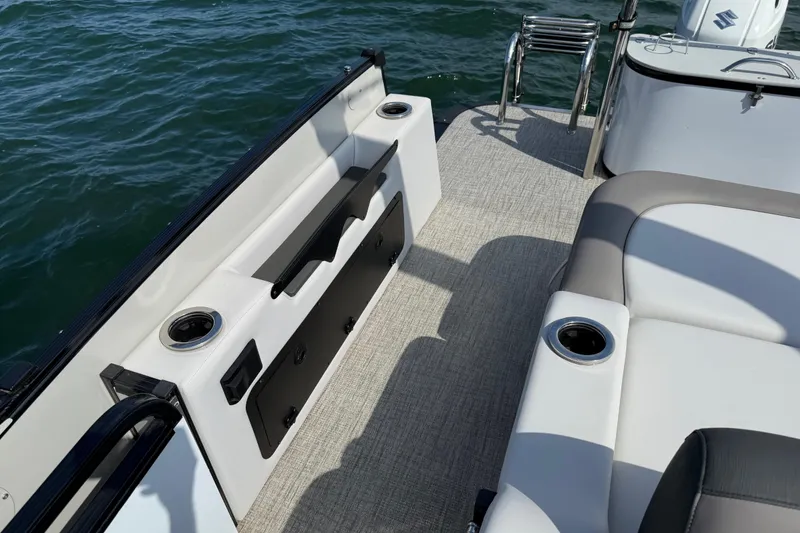 Slide: The Image of 2023 Avalon Catalina Versatile Rear Bench boat interior with seating and cup holders. - 26
