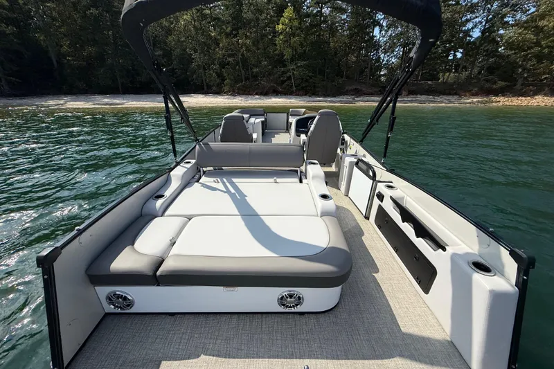 Slide: The Image of 2023 Avalon Catalina Versatile Rear Bench boat on water, featuring spacious seating and modern design. - 29
