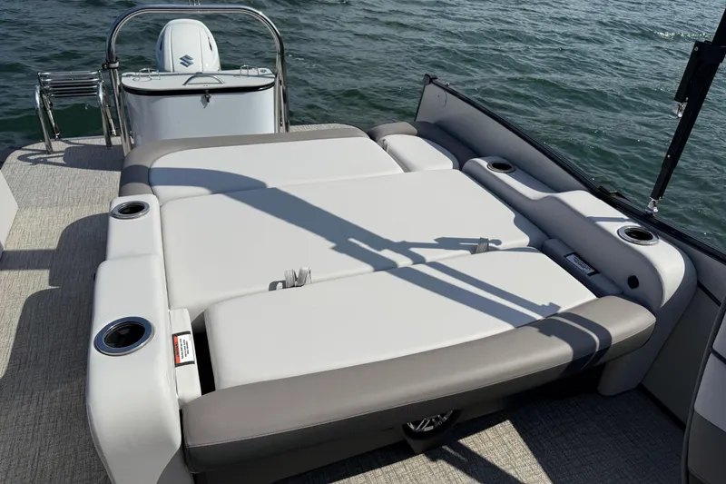 Slide: The Image of 2023 Avalon Catalina Versatile Rear Bench on water, showcasing luxurious seating and cup holders. - 34