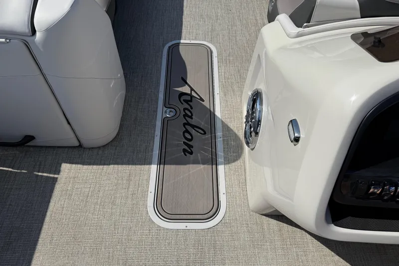 Slide: The Image of 2023 Avalon Catalina Versatile Rear Bench boat interior with logo on deck. - 35