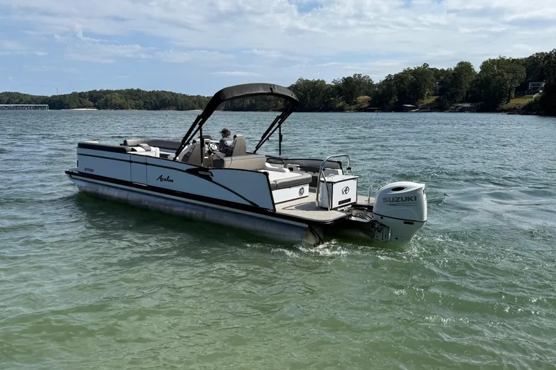 Slide: The Image of 2023 Avalon Catalina Versatile Rear Bench boat on a scenic lake. - 5