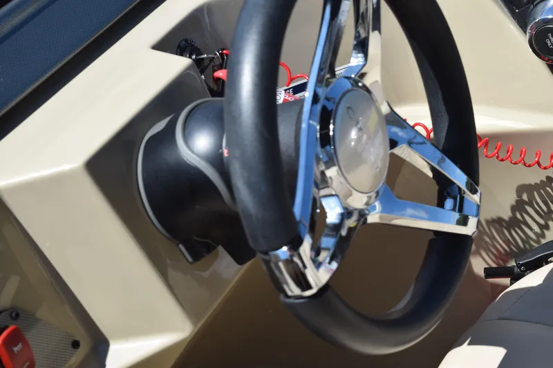 Slide: The Image of 2024 Crest Classic LX 220 L steering wheel with chrome accents and control panel. - 21