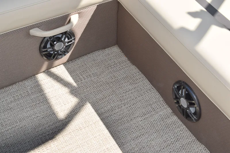 Slide: The Image of 2024 Crest Classic LX 220 L interior with speakers and textured flooring. - 24