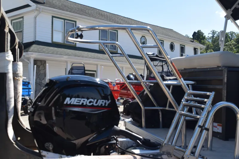 Slide: The Image of 2024 Crest Classic LX 220 L boat with Mercury engine, docked near a house. - 3