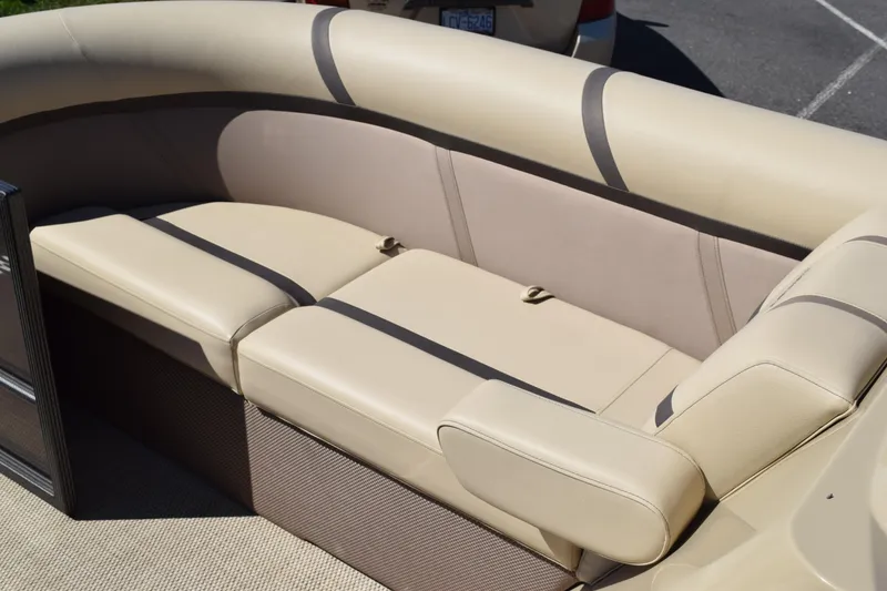 Slide: The Image of 2024 Crest Classic LX 220 L boat seating, beige upholstery with dark accents. - 9