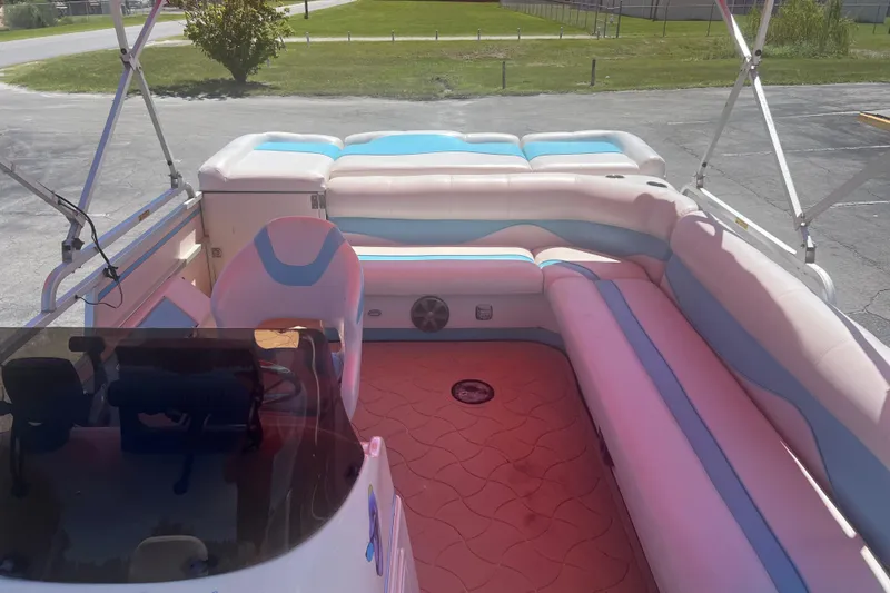 Slide: The Image of Interior of a 2005 G3 LX20 boat with pastel seating and steering console. - 10