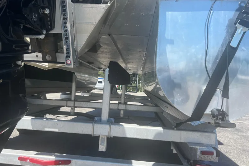 Slide: The Image of 2005 G3 LX20 boat on trailer, showing underside and motor mount details. - 15