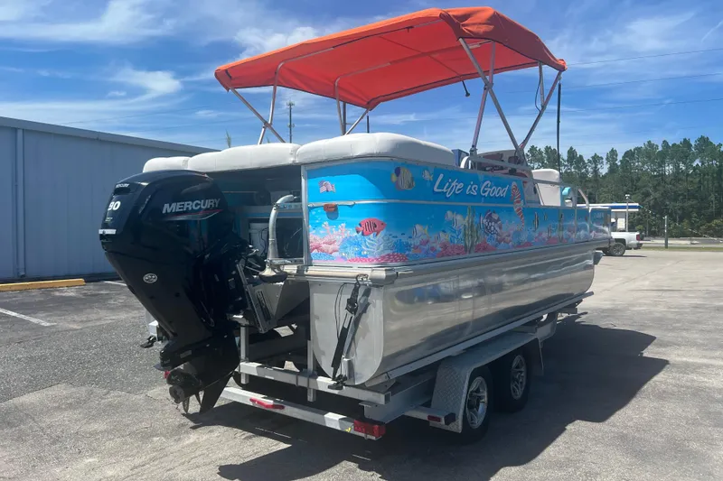 Slide: The Image of 2005 G3 LX20 boat with vibrant marine graphics and Mercury outboard motor. - 8