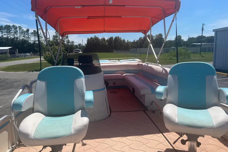 Slide: The Image of 2005 G3 LX20 boat interior with red canopy and blue seats. - 9