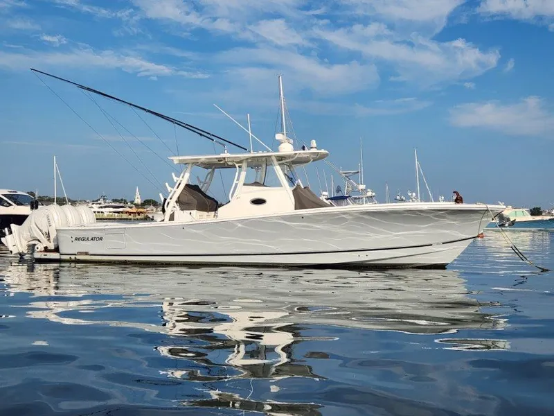 The Image of 2022 Regulator 37 boat on calm water under a clear blue sky. - 0