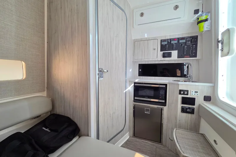 Slide: The Image of 2022 Regulator 37 cabin interior with kitchenette, microwave, and control panel. - 18