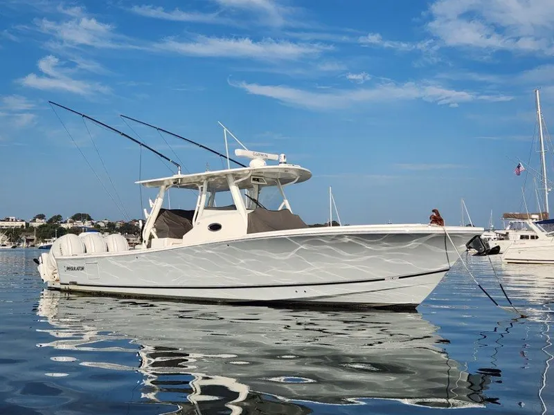 Slide: The Image of 2022 Regulator 37 boat on calm water under a clear blue sky. - 2