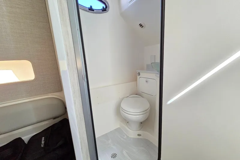 Slide: The Image of 2022 Regulator 37 boat bathroom interior with toilet and window. - 20