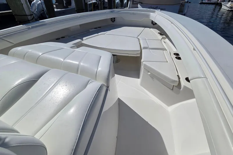 Slide: The Image of 2022 Regulator 37 boat interior with white seating and table, docked at marina. - 3