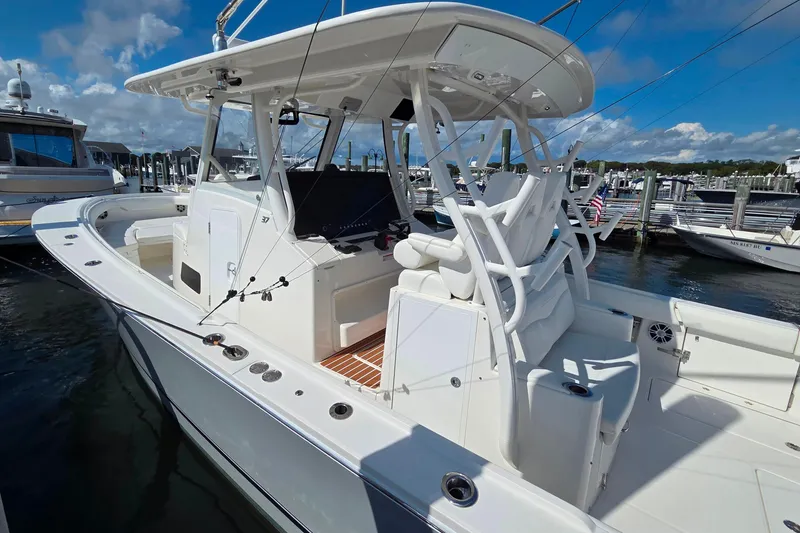 Slide: The Image of 2022 Regulator 37 boat docked at marina under clear blue sky. - 7