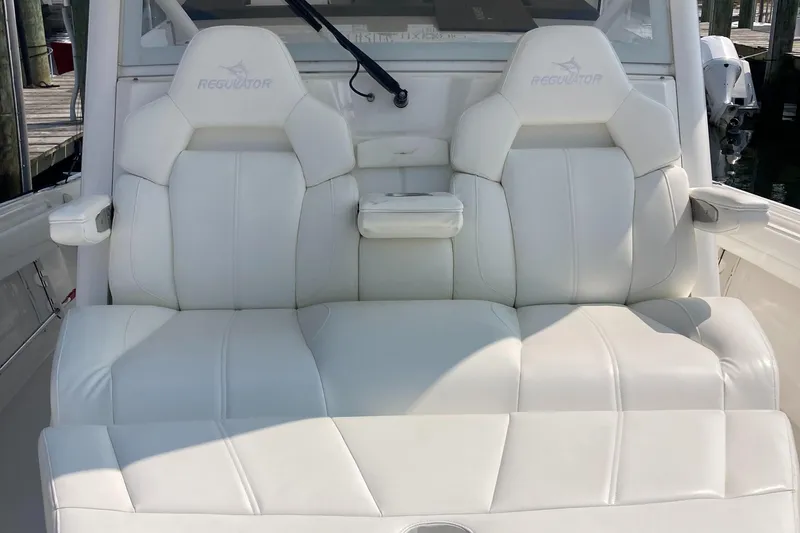 Slide: The Image of 2022 Regulator 37 boat with luxurious white seating and armrest. - 8