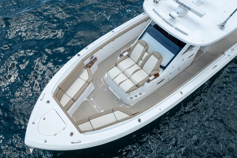 Slide: The Image of 2021 Everglades 395 Center Console boat on water, featuring luxurious seating and sleek design. - 12