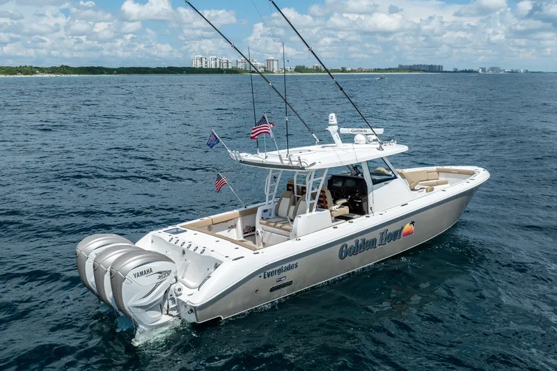 Slide: The Image of 2021 Everglades 395 Center Console boat cruising on open water with fishing rods. - 15