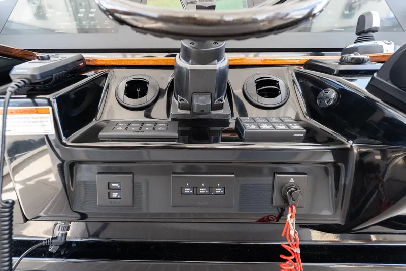 Slide: The Image of 2021 Everglades 395 Center Console dashboard with controls and steering wheel. - 20