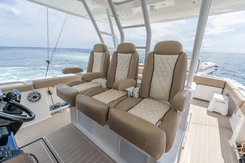 Slide: The Image of Luxurious seating on 2021 Everglades 395 Center Console boat, ocean view in background. - 28