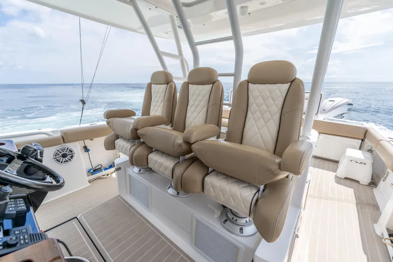 Slide: The Image of Luxurious seating on 2021 Everglades 395 Center Console boat, ocean view in background. - 29