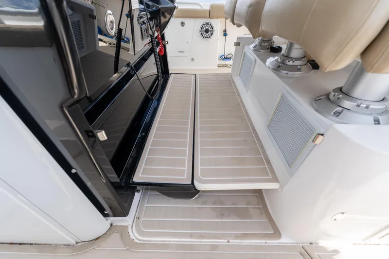 Slide: The Image of 2021 Everglades 395 Center Console interior with beige seating and sleek design. - 30