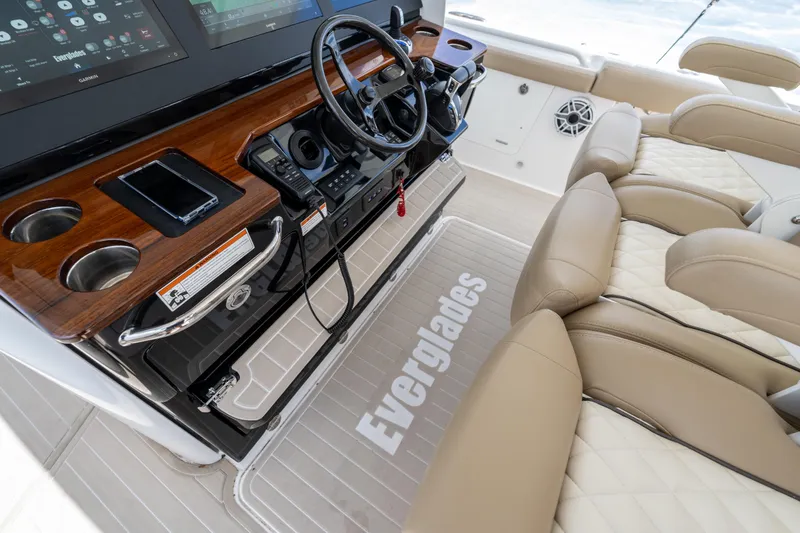 Slide: The Image of 2021 Everglades 395 Center Console boat interior with luxurious seating and advanced controls. - 31