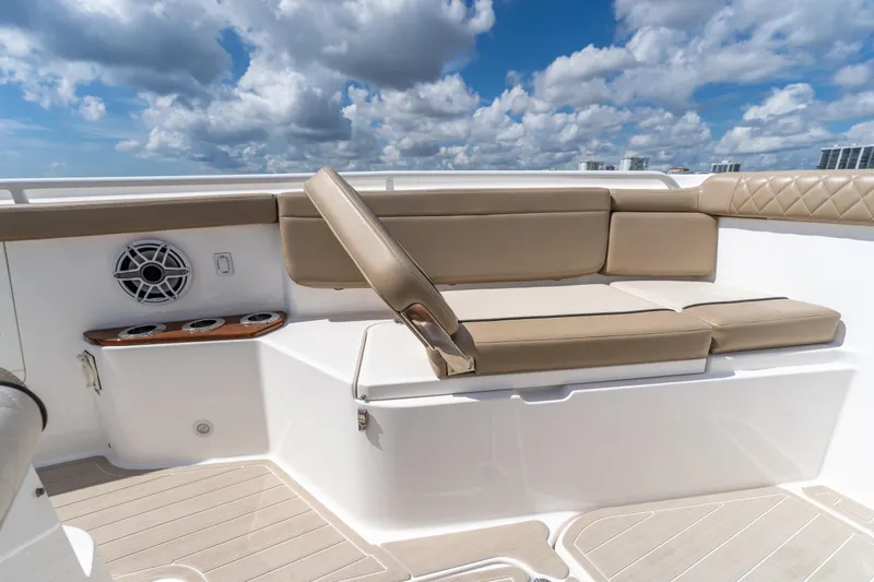 Slide: The Image of Luxurious seating on 2021 Everglades 395 Center Console boat under a vibrant sky. - 37