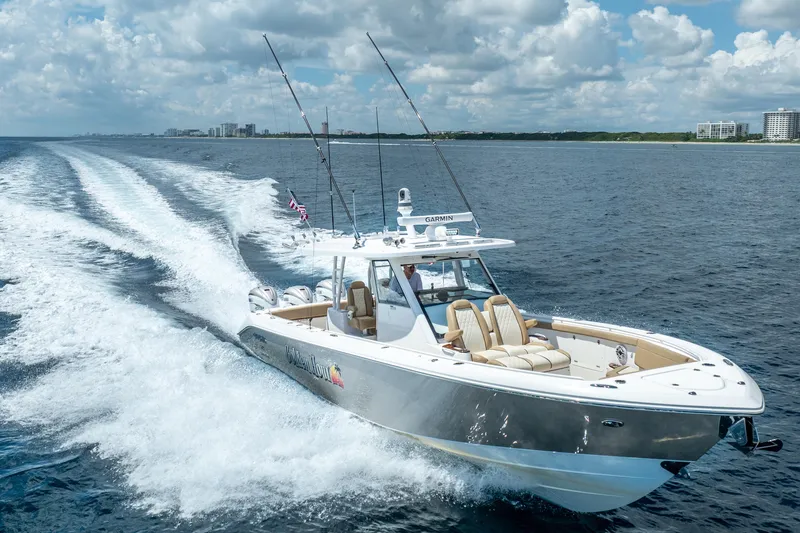 Slide: The Image of 2021 Everglades 395 Center Console boat cruising on open water under a cloudy sky. - 4
