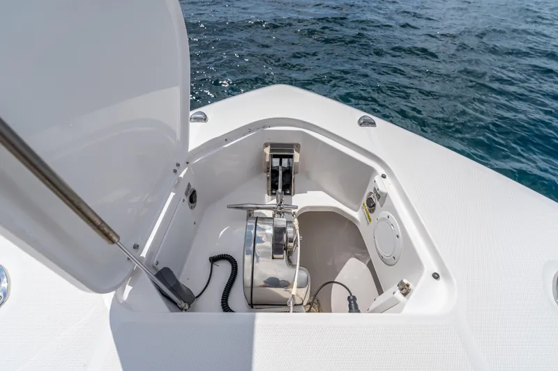Slide: The Image of 2021 Everglades 395 Center Console anchor compartment with open hatch, ocean background. - 43