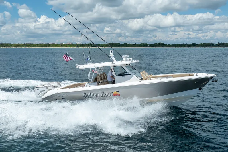 Slide: The Image of 2021 Everglades 395 Center Console boat cruising on open water under a cloudy sky. - 5