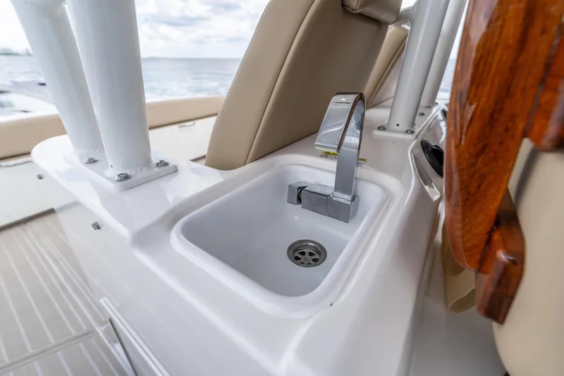 Slide: The Image of Everglades 395 Center Console 2021 boat sink with modern faucet, ocean in background. - 50