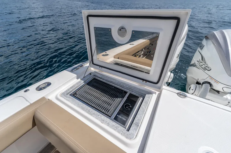 Slide: The Image of 2021 Everglades 395 Center Console boat with Kenyon grill, open hatch, and Yamaha engine. - 58