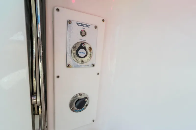 Slide: The Image of Control panel of 2021 Everglades 395 Center Console boat's outboard flushing system. - 59