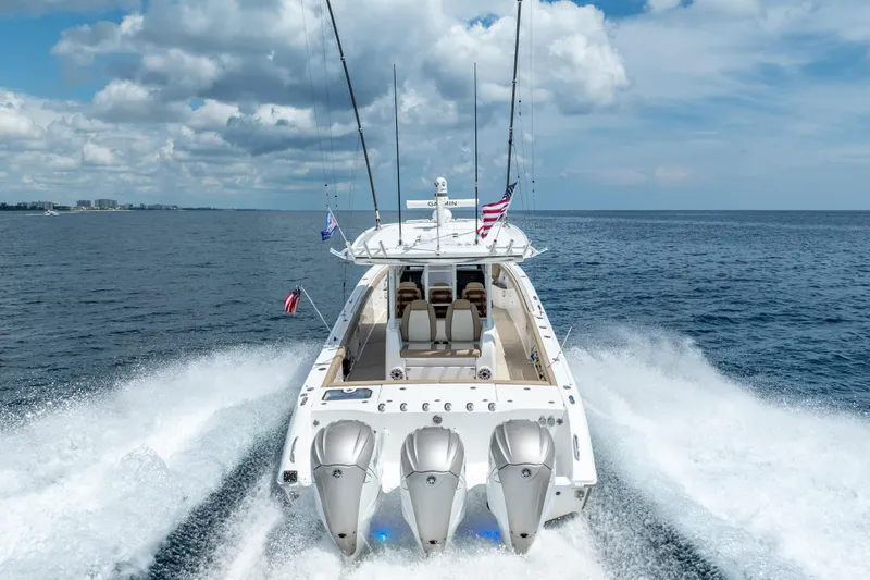 Slide: The Image of 2021 Everglades 395 Center Console boat cruising on open water, rear view. - 6