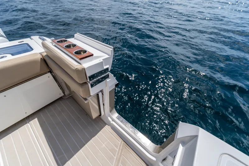 Slide: The Image of 2021 Everglades 395 Center Console boat with cup holders, near ocean water. - 62