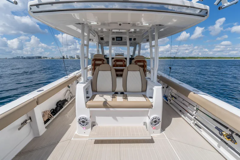 Slide: The Image of 2021 Everglades 395 Center Console boat interior with seating, ocean view, and clear skies. - 64