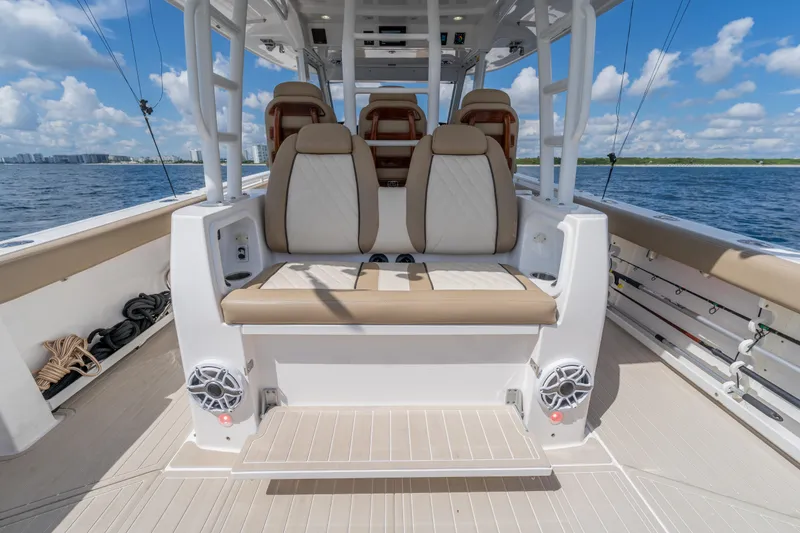 Slide: The Image of 2021 Everglades 395 Center Console boat interior with seating, ocean view, and clear sky. - 65